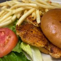 Breaded Pork Tenderloin · Breaded pork tenderloin fried golden brown and served with lettuce, tomatoes, onion, mayonna...