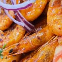Camarón / Shrimp · Camarones sazonados, servidos con lechuga, tomate y nuestro aderezo especial para empanadas....