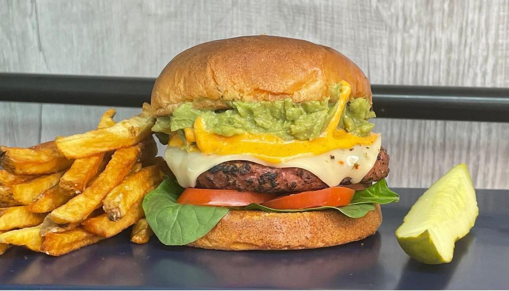 The Zack · House-made burger patty with pepperjack cheese, spinach, tomato, and smashed avocado, with creamy jalapeno sauce on a toasted brioche bun