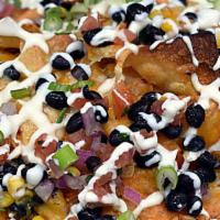 Box Nachos · house-tortilla chips, roasted corn & black bean salsa, cheddar jack, habanero aioli