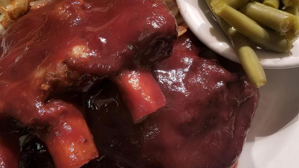 Bbq Pork Ribs · Gluten free. A full slab of our juicy lip smacking' barbecue ribs smothered in our homemade barbecue sauce.