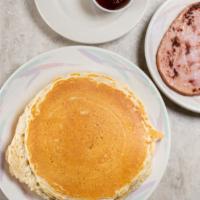 Golden Pancakes · Three fluffy golden pancakes served with butter and syrup.