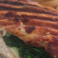 Chicken Pesto Panini · Grilled chicken breast topped with spinach and melted Mozzarella cheese. Served on grilled f...