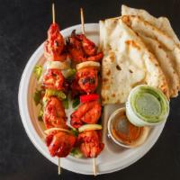 Chicken Tikka · Cubes of marinated chicken cooked in tandoor oven topped with green peppers and onions.