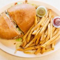 Torta · Steak or chicken torta topped with beans, lettuce, tomatoes, mayo, avocado, and cheese, serv...
