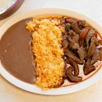 Bistec De Res · Bistec de Res served with rice and beans, with fresh tortillas.