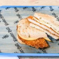 Schnitzel Sandwich · Hand breaded, deep fried pork loin on German rye with smoked Gouda and house mustard.