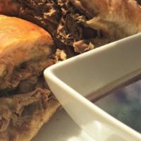 French Dip · Shaved slow roasted beef topped with provolone cheese and toasted on a French roll served wi...
