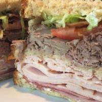 The Dagwood · Layers of roast beef, ham, turkey, and bacon on whole wheat bread stacked three high with le...