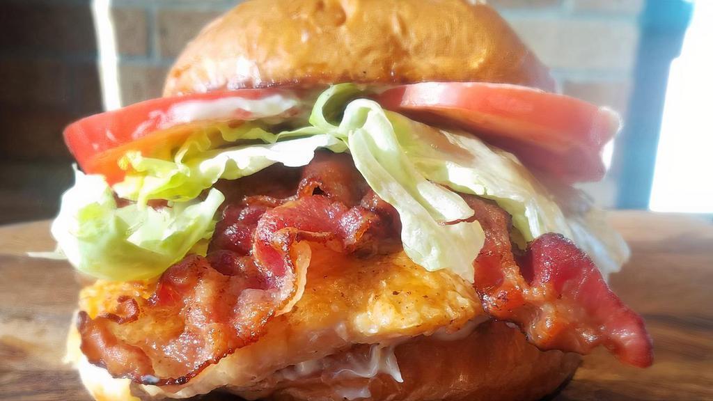 Chicken Club · New, chef recommended. Grilled chicken breast and applewood smoked bacon on a toasted brioche bun topped with lettuce, tomato, and mayo.