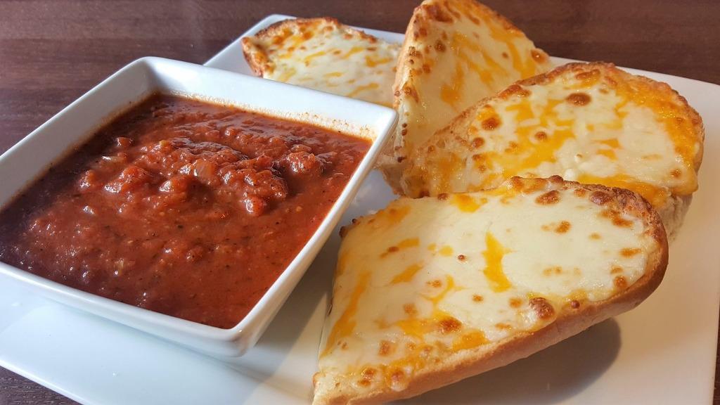 Cheese Bread · A blend of Italian cheeses placed on a garlic butter French roll and baked. Served with a side order of meat or marinara sauce for dipping.
