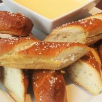 Pretzel Sticks · Baked to perfection and sprinkled with sea salt. Served with a side of our homemade Gouda ch...