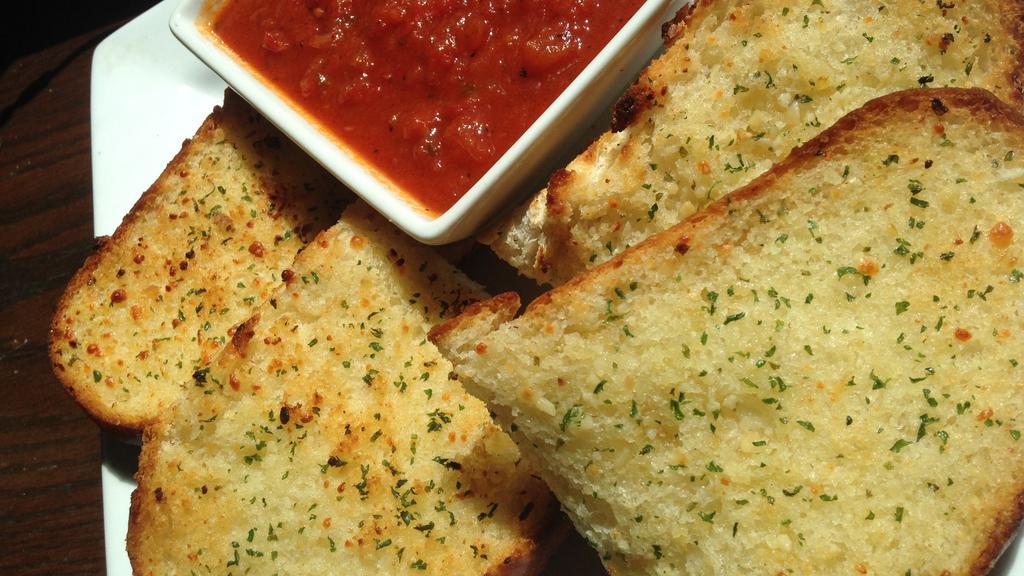 Garlic Bread · A French roll topped with butter, garlic, and Italian seasonings, served with sauce for dipping.