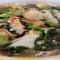 Rad Na Talay Seafood · Wide rice noodles with vegetables and seafood, stir-fried in a dark soy sauce and covered wi...