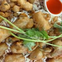 Golden Calamari/ ปลาหมกึทอด · Crispy tempura style calamari with a hint of spices and green onions. Served with sriracha d...