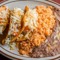 Corn Tacos · Three corn tortillas, fried and stuffed with your choice of filling and topped with lettuce ...