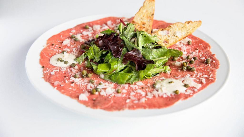 Wagyu Beef Carpaccio · Chilled wagyu beef sliced razor thin.

Contains raw or undercooked ingredients. Consuming raw or undercooked meats, poultry, seafood or shellfish may increase your risk of foodborne illness, especially if you have certain medical conditions.