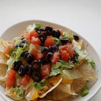 Nachos · Lettuce, tomato, black olives, ground beef, jalapenos, and nacho cheese with a side of sour ...