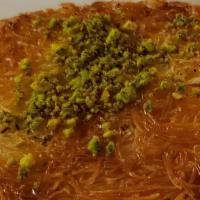 Kunefe · Shredded filo pastry soaked in syrup, layered with sweet cheese and topped with pistachios.