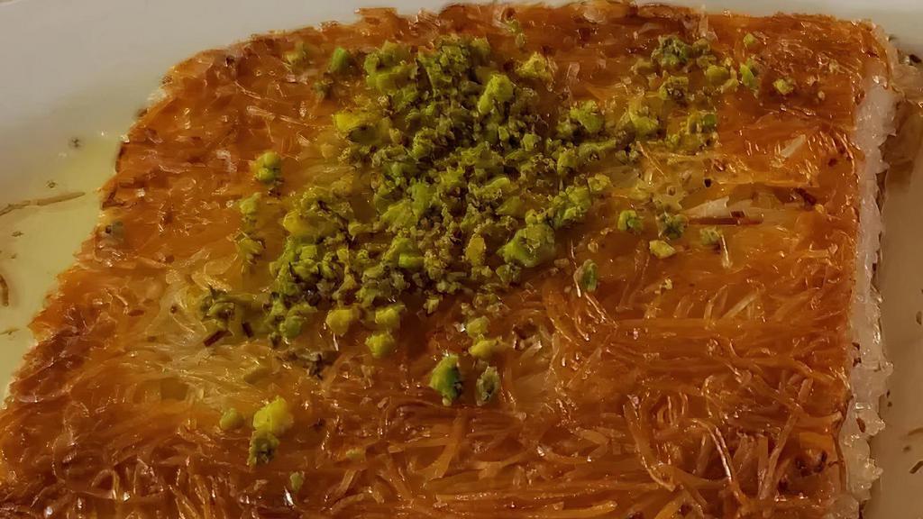Kunefe · Shredded filo pastry soaked in syrup, layered with sweet cheese and topped with pistachios.