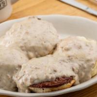 Country Benedict · Two split biscuits, 2 poached eggs & 2 sausage patties, topped with sausage gravy