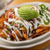 Chilaquiles · Tortilla chips topped with our house-made red & green salsas, 2 eggs your way, pickled onion...
