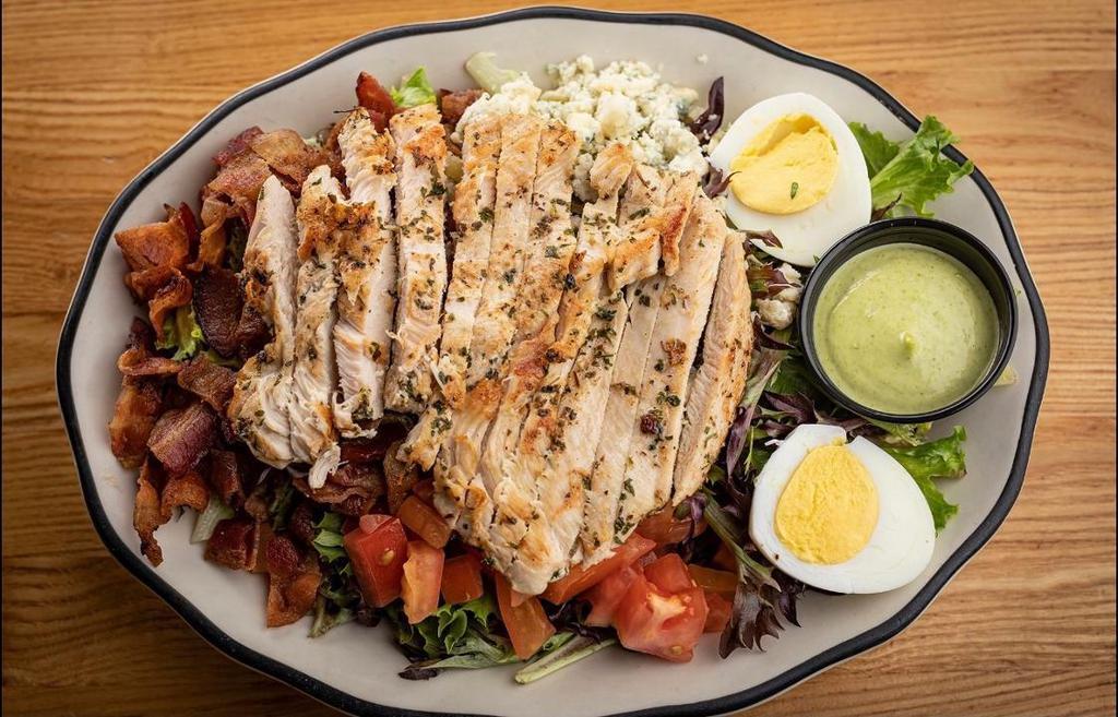 Cobb Salad · Mixed greens with grilled chicken breast, bacon, avocado, egg, tomato and bleu cheese. With green goddess dressing.