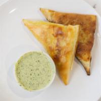 Chicken Samosa · Ground chicken, onion and peas. Served with green with envy chutney.

Halal
Pan fried with o...
