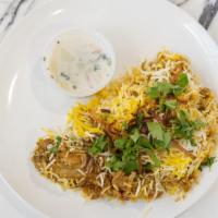Chicken Biryani · Rice, Chicken, and delicious spices. 
Served with Raita (yogurt with vegetables)
topped with...