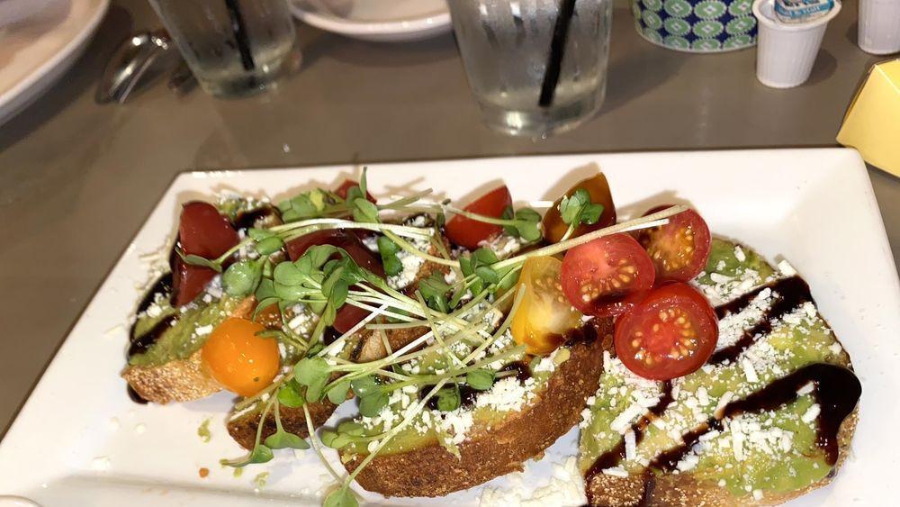 Avocado Toast  · sourdough, heirloom tomato, cotija, radish, pickled red onion, balsamic reduction, sprouts
