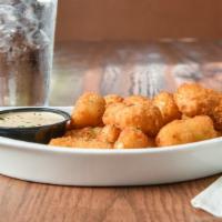 Cheese Curds · Crispy Wisconsin cheese curds served  with smoked pepper ranch sauce