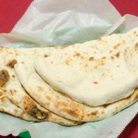 #85. Naan · Fine white bread baked with almond in tandoor.