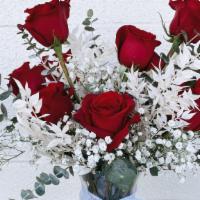 1 Dozen Roses · A dozen red roses and baby’s breath with touches of dried, bleached Ruscus in a clear vase. ...