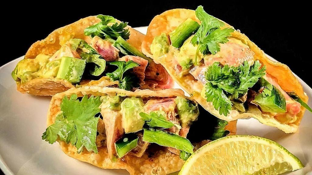 Tuna Wonton Tacos · Raw. Seared tuna, avocado, spicy wasabi aioli, cilantro.
