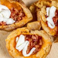 Potato Skins · Topped with Cheddar cheese and bacon, served with sour cream and salsa.