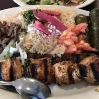 Combination Plate Combo Meal · Shish tawook, shish kafta, meat shawarma, grape leaves, hummus, rice, and salad.