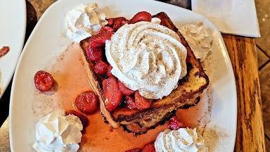 Stuffed French Toast · Redford Grill's french toast combined with our homemade cream cheese-based filling. Topped with your whipped cream and cinnamon.
