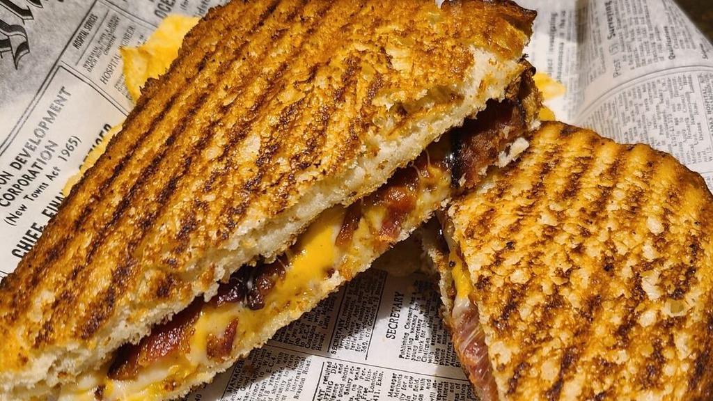 Grilled Cheese · American and provolone cheese. Served with a pickle and chips on bread. Substitute chips for a salad for an additional charge.