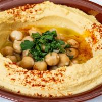 Hummus · Vegan. Our signature blend of pureed chickpeas, tahina, garlic and lemon, topped with extra ...