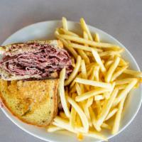 The Woodward Reuben · Our house cut double baked rye bread grilled, Sy Ginsberg corned beef cooked with our house ...