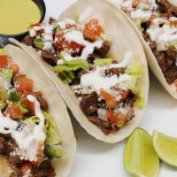 Mexcian Chorizo Tacos Rancheros · 4 Mexican Chorizo Tacos, topped with pico de gallo, sour cream, cotija cheese and lettuce on...