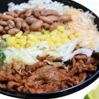 Carne Asada Burrito Bowl · Marinated, thinly sliced grilled steak burrito bowl topped with lime rice, choice of beans, ...
