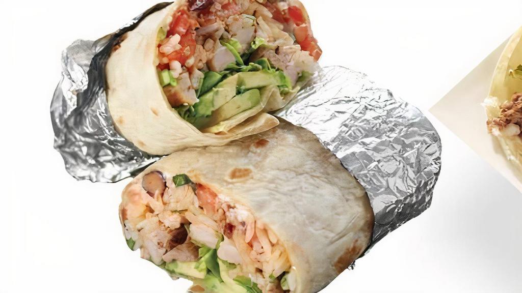Chicken Tortilla Burrito · Marinated grilled Chicken burrito stuffed with zesty lime rice, with choice of beans, pico de gallo, corn, choice of sauce, sour cream, cotija cheese and lettuce.