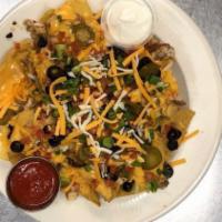 Chicken Nacho Supreme · Fresh corn tortilla chips with a sliced grilled chicken breast drizzled with queso, pico, ja...