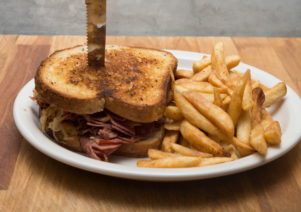 The Reuben · Lean corned beef thinly sliced in house, sauerkraut, thousand island dressing and Swiss cheese on golden toasted rye bread.