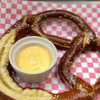 Jumbo Pretzel · Jumbo pretzel deep fried to a perfect soft golden brown and severed with house-made beer che...
