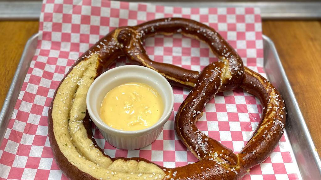 Jumbo Pretzel · Jumbo pretzel deep fried to a perfect soft golden brown and severed with house-made beer cheese or spicy mustard.