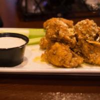 Boneless Wings · Served by the pound, try them tossed in a sauce of your choice. Served with Blue cheese or r...