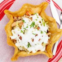 Taco Salad · Taco salad served with, beans, lettuce, cheese, sour cream, tomato and choice of meat, serve...