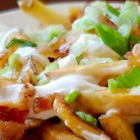 Disco Fries · Fresh cut fries, bacon, cheese sauce, green onion, sour cream